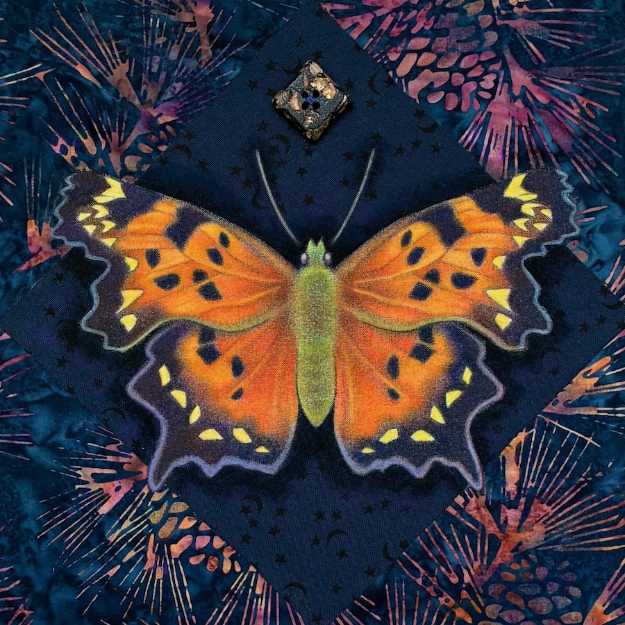 Green comma butterfly drawing in an art fabric collage